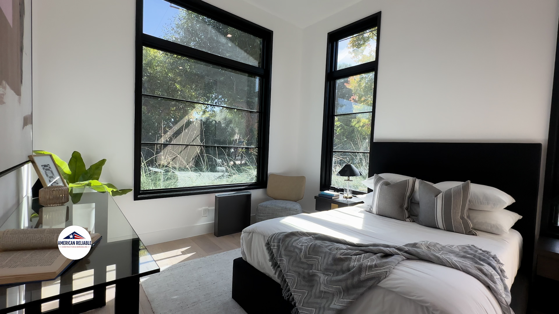 Serene bedroom with large windows and reading nook