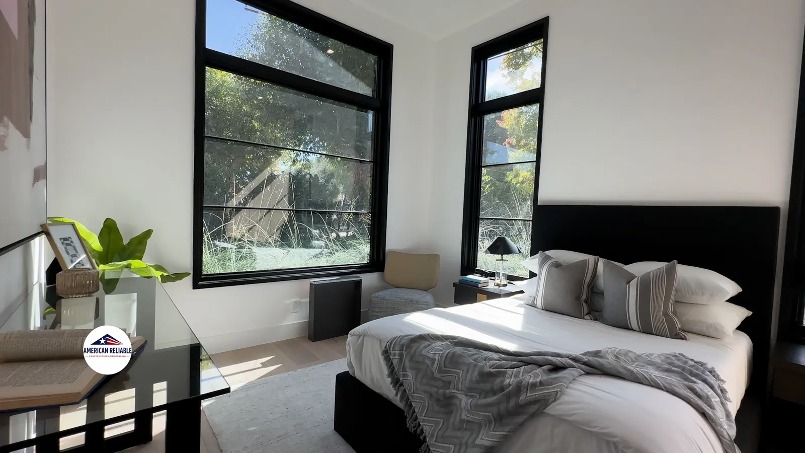 Serene bedroom with large windows and reading nook