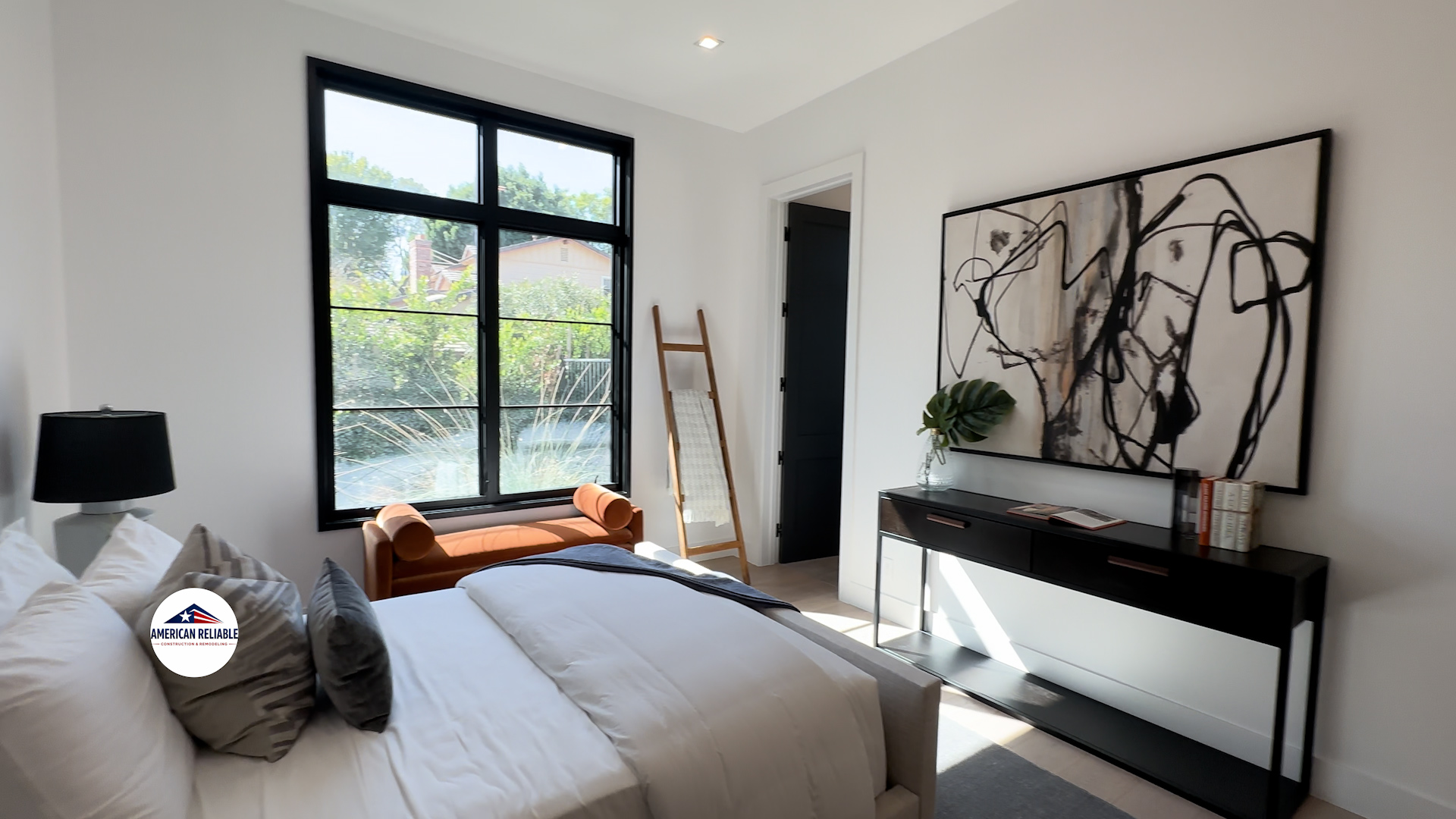 Guest bedroom with abstract art and leather daybed