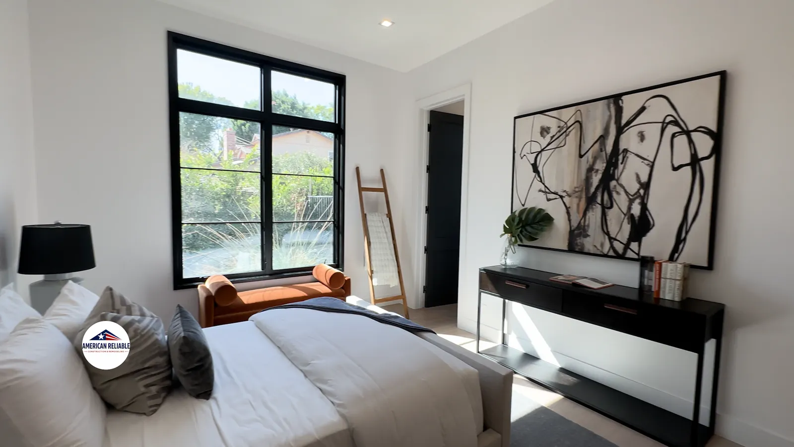Guest bedroom with abstract art and leather daybed