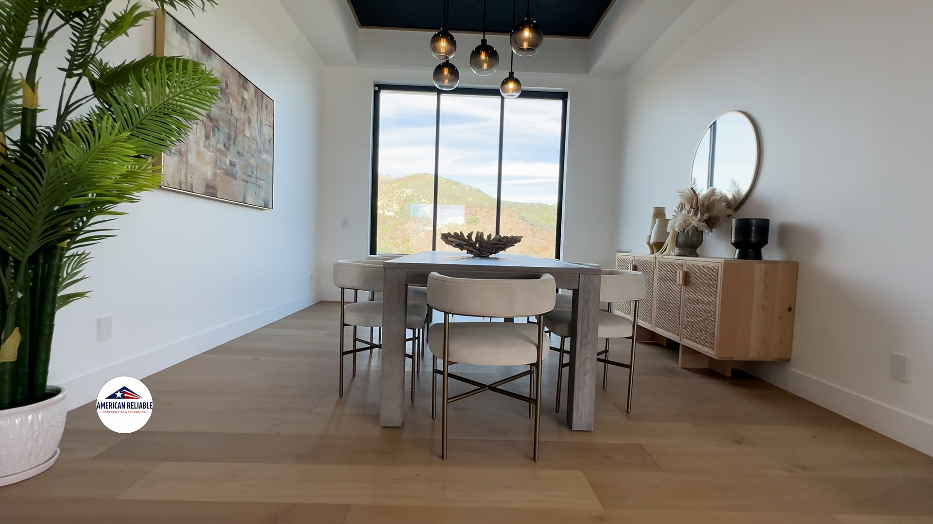 Elegant dining room with pendant lighting and mountain views