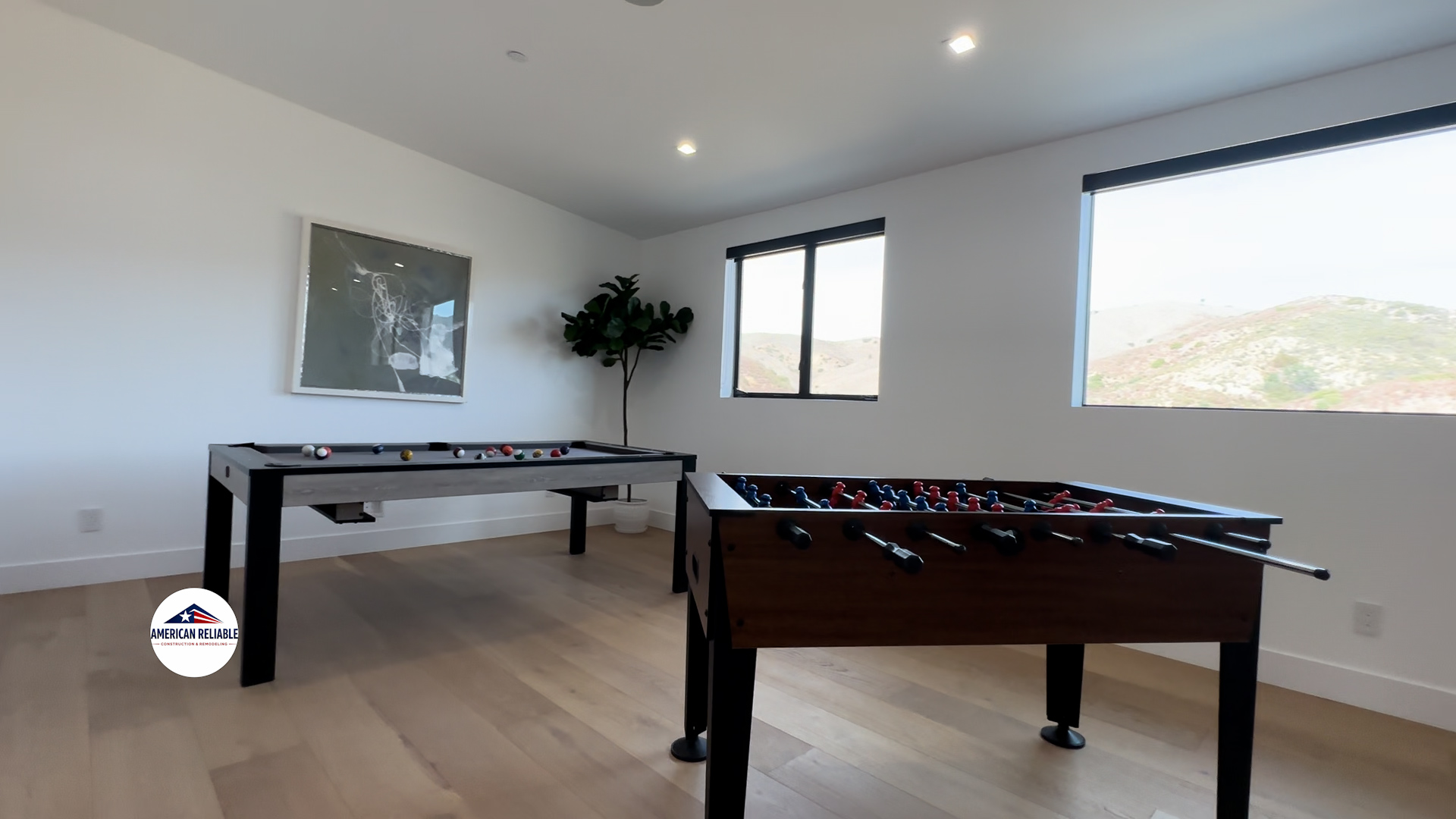 Modern game room with pool table and foosball