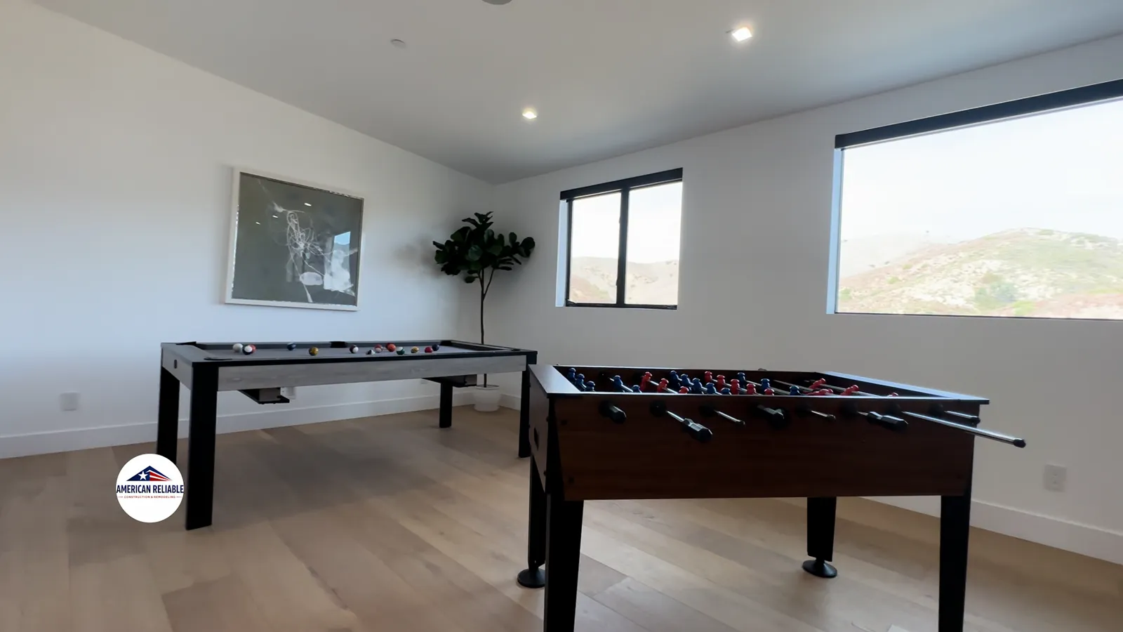 Modern game room with pool table and foosball