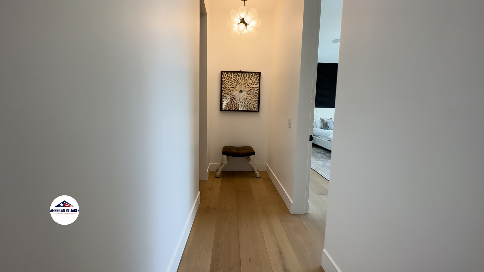 Modern hallway with hardwood flooring and designer lighting