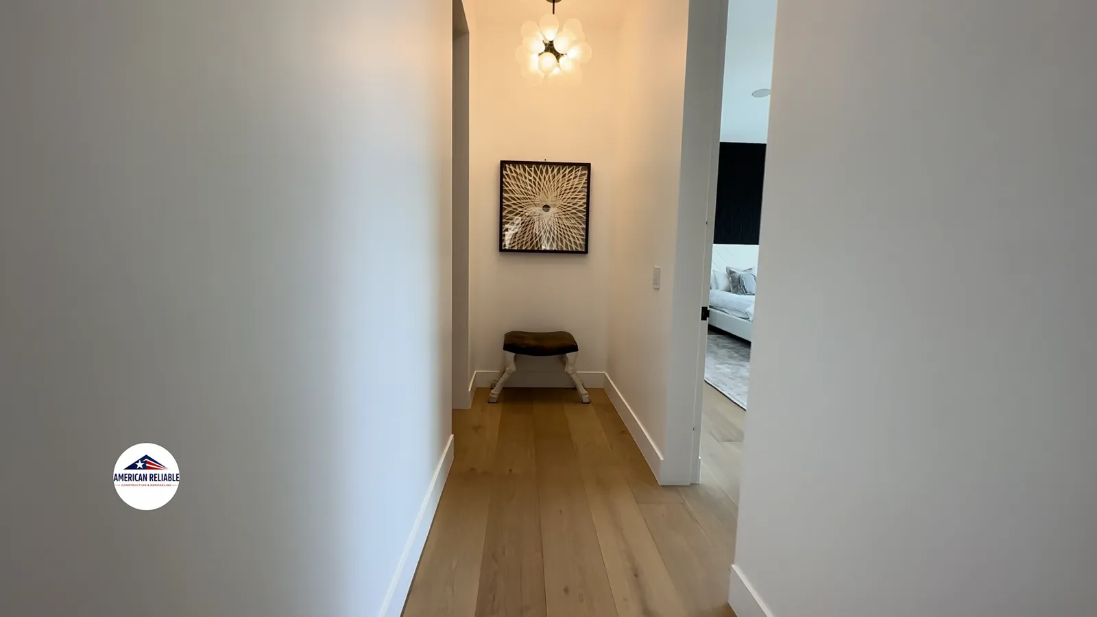 Modern hallway with hardwood flooring and designer lighting