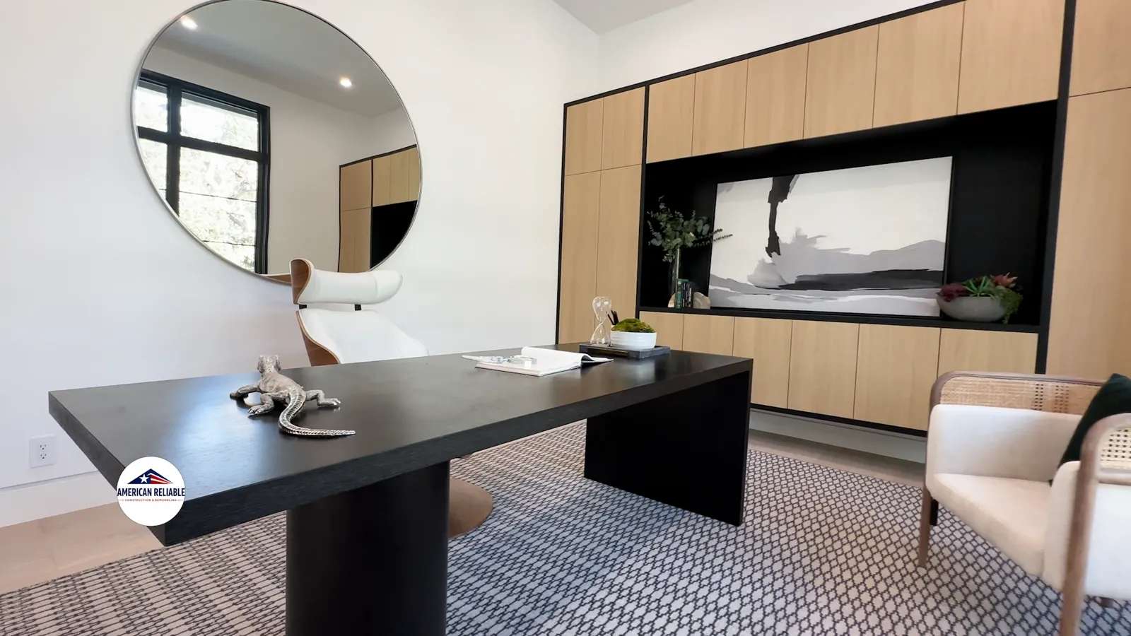 Modern office with black desk and round mirror