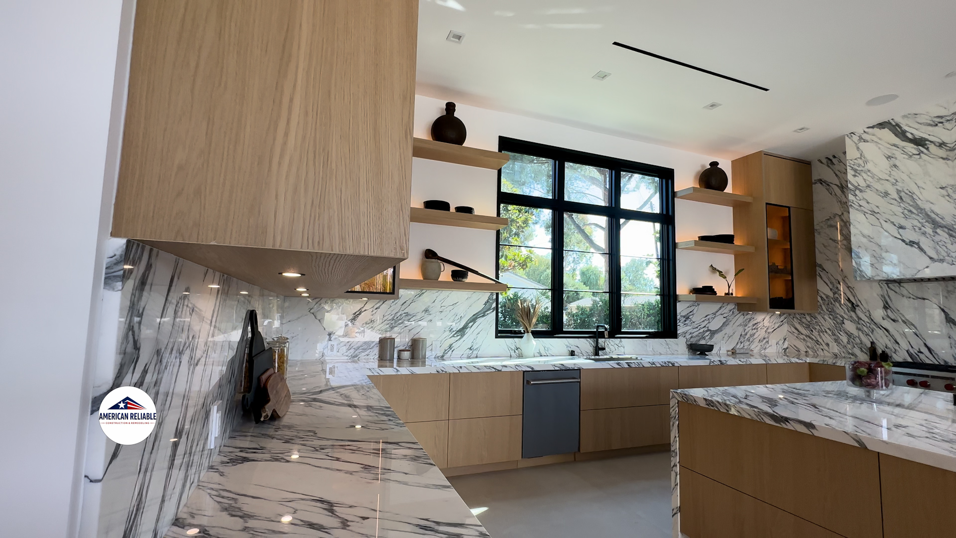 Modern kitchen with marble counters and oak cabinetry