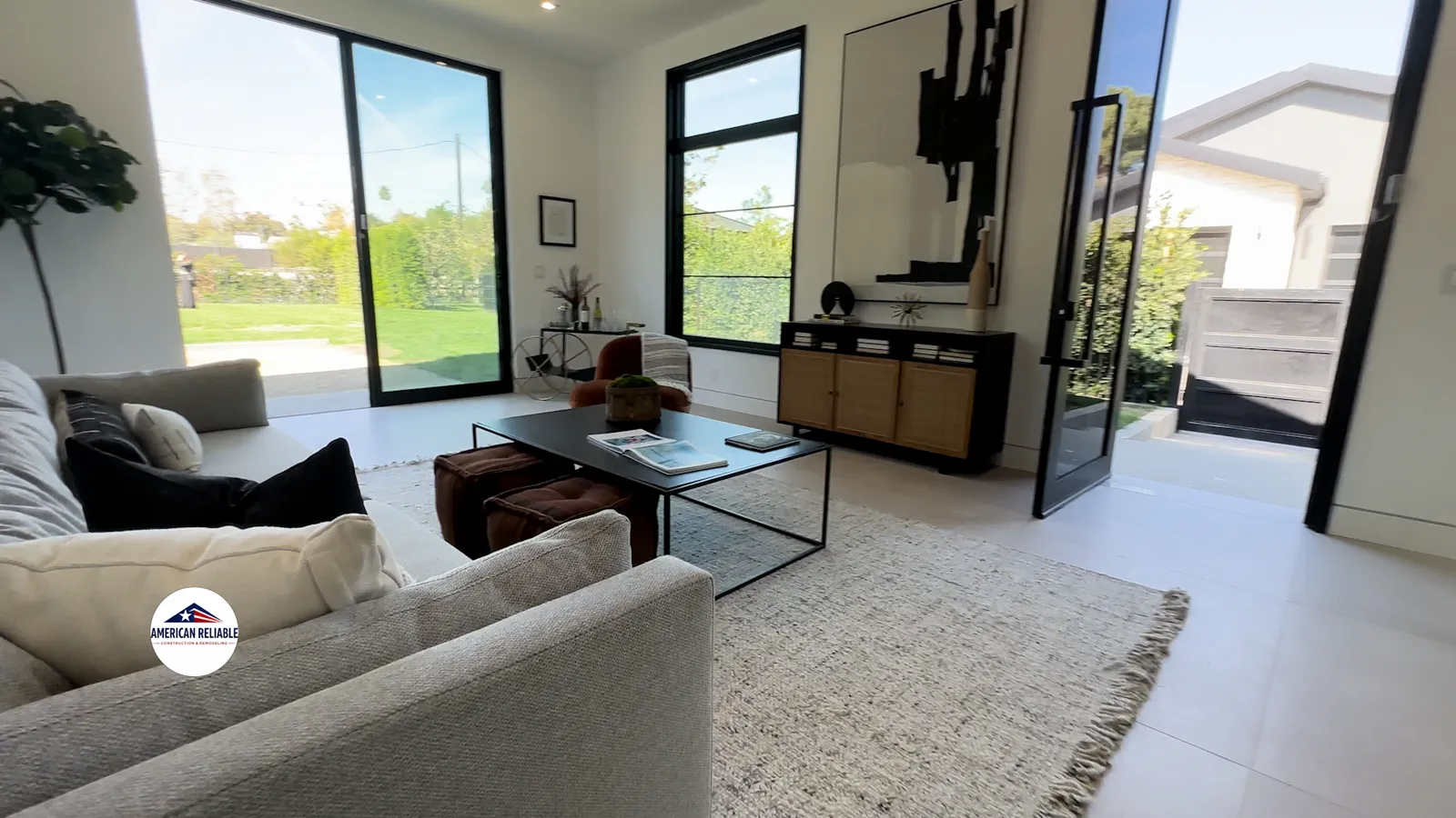 Bright living room with floor-to-ceiling windows and garden views